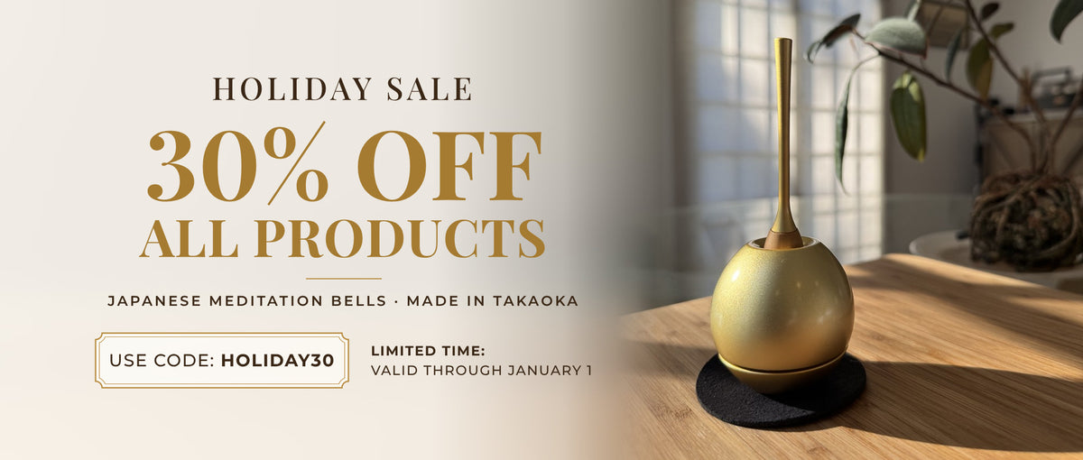 Holiday Sale: 30% off all products with code HOLIDAY30, valid through January 1. A gold orin, a Japanese meditation bell, on a wooden table by a sunlit window.